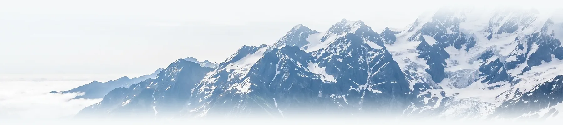 Snow-covered peaks above a valley.